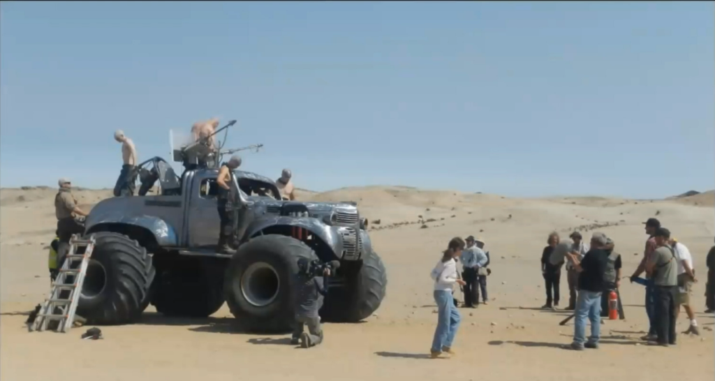 Photo on the set of Mad Max - Fury Road, the actors are mounting  the war rig at the start of a shoot
