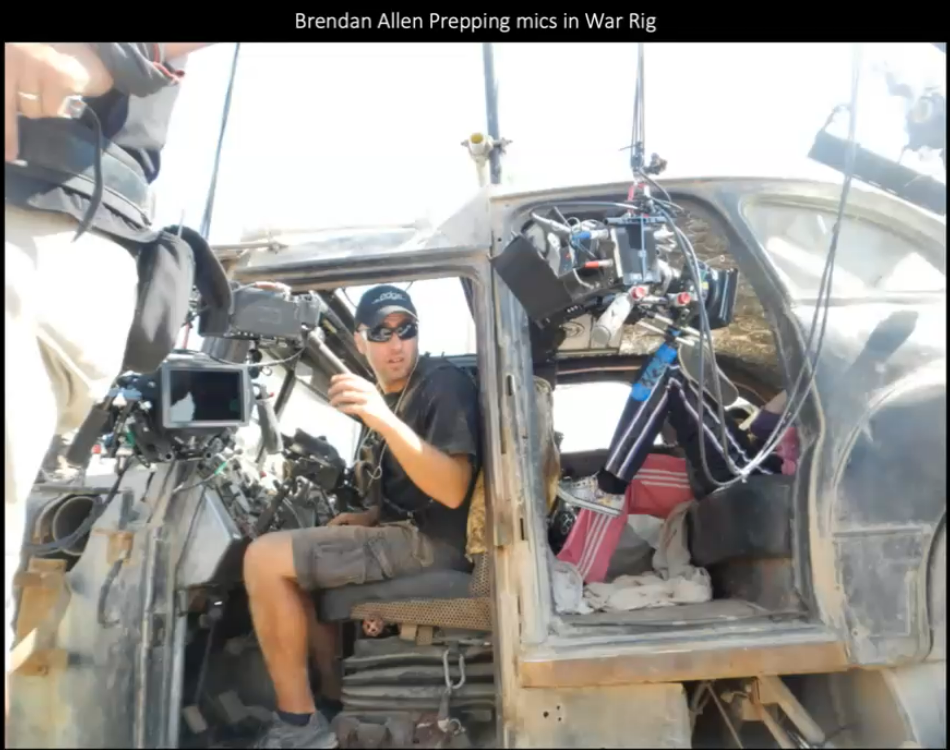 Photo on the set of Mad Max - Fury Road, showing a  member of the audio crew fitting microphones to a war rig.