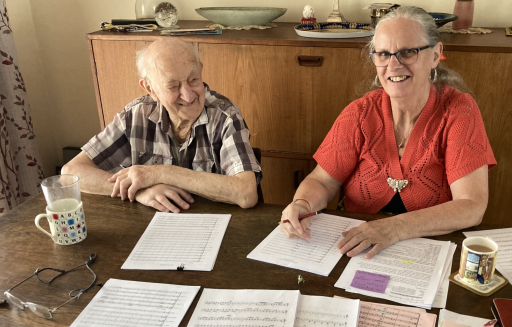 Monty Maizels and Mary Louise Wright studying the score for Monty's symphonic composition